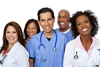 Picture of three female Physicians and two male Nurses smiling